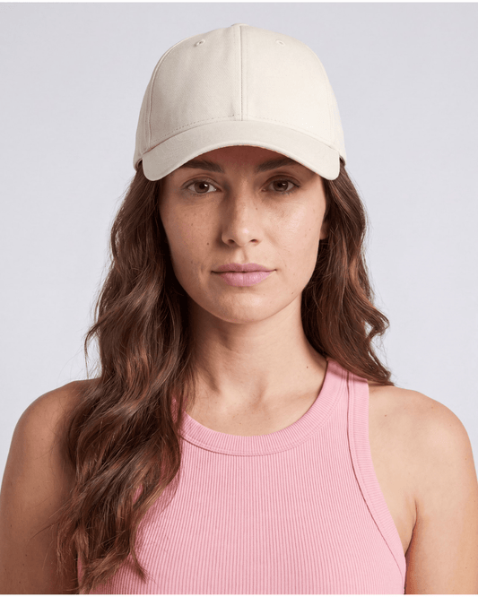 Cream cotton twill cap worn front on, soft unstructured crown and curved brim